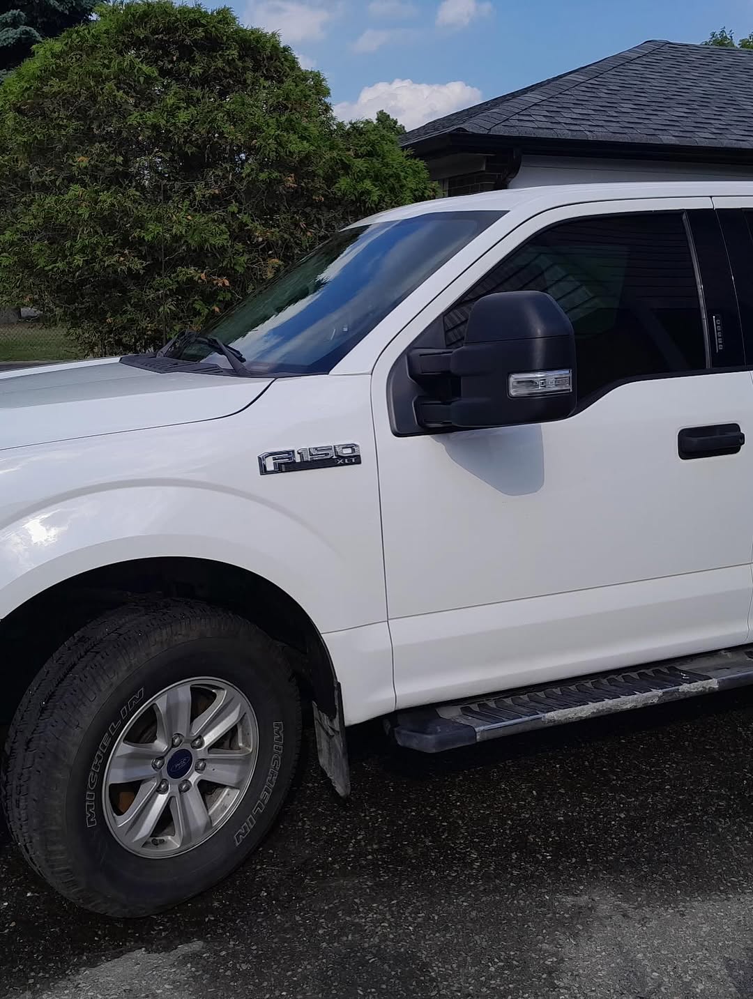 Finished white Ford F-150 XLT, front three-quarter view